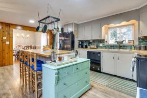 a large kitchen with blue cabinets and a blue island at Charming Wilton Vacation Rental with Fire Pit in Wilton