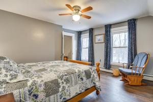 a bedroom with a bed and a ceiling fan at Charming Wilton Vacation Rental with Fire Pit in Wilton