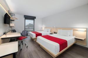 Postel nebo postele na pokoji v ubytování City Express by Marriott Silao Aeropuerto