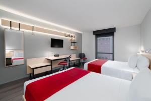 Postel nebo postele na pokoji v ubytování City Express by Marriott Silao Aeropuerto