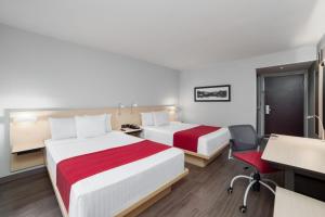 Postel nebo postele na pokoji v ubytování City Express by Marriott Silao Aeropuerto