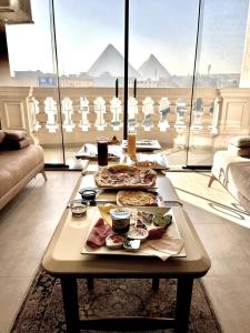 a table with food on it in a living room at Pyramids Charm Hotel in Cairo