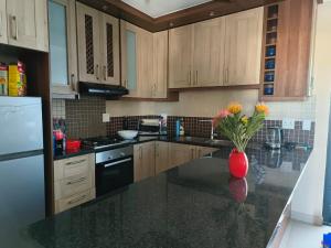 a kitchen with a vase of flowers on a counter at Frank's Place in Yzerfontein +13 photos