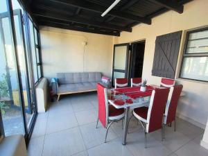 a room with a table and chairs and a couch at Frank's Place in Yzerfontein