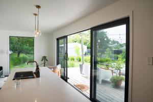 a kitchen with a large glass door leading to a patio at The Gallery in Havelock North in Havelock North