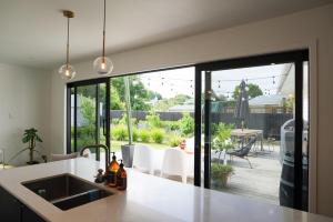 a kitchen with a large window looking out onto a patio at The Gallery in Havelock North in Havelock North