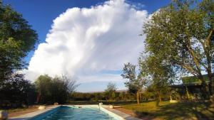 a large swimming pool in a park with a cloudy sky at las tacanas casa del alto in Nono +9 photos