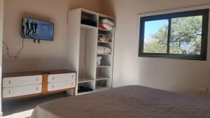 a bedroom with a bed and a window at las tacanas casa del alto in Nono