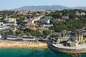 an aerial view of a beach with people in the water at Historic Town Cascais Modern Apartment in Cascais