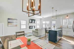 a dining room and living room with a table and a kitchen at Modern Greer Retreat Walk to Historic Downtown! in Greer