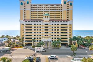 a large hotel with the ocean in the background at Camelot by the Sea - Oceana Resorts Vacation Rentals in Myrtle Beach