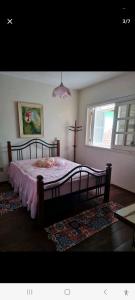 Een bed of bedden in een kamer bij Quarto _ Temporada , Feriados_ Torres RS