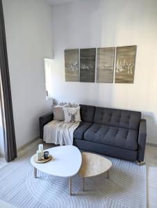 a living room with a couch and a table at La Suite Côté Parc (Superbe T2 classé 4*) in Saint-Martin-dʼUriage