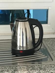 a black and silver tea kettle sitting on a stove at Dream House in Houmt Souk