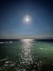 a view of the ocean with the moon in the sky at 銚子グランドホテル in Choshi