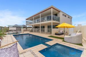 a house with a swimming pool and a building at Luxury Sunset & Surf in Halls Head in Wannanup