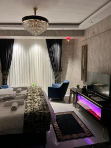 a bedroom with a bed and a tv and a couch at Luxury Suite Golden Horn in Istanbul