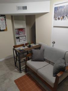 a living room with a couch and a table at Guest house in a quiet peaceful area. in Mariners Harbor