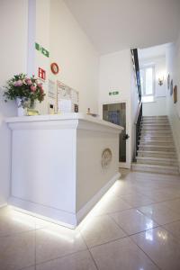 un mostrador blanco en una habitación con escalera en Hotel Amalfi, en Milán