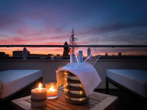 a candle is lit on a table in front of a sunset at Palazzo Bezzi Hotel in Ravenna