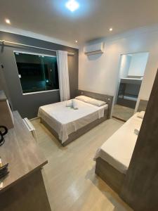 En eller flere senge i et værelse på Savanna Suites - Beto Carrero