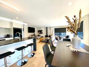 a kitchen and living room with a table and chairs at Executive Comfort in Twizel