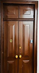 a wooden door in a building at Suites Luciano Cordeiro in Lisbon