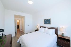 a bedroom with a large white bed with white pillows at Pioche Village in Park City