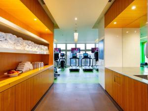 a gym with treadmills and exercise equipment in a building at Sofitel Brisbane Central in Brisbane