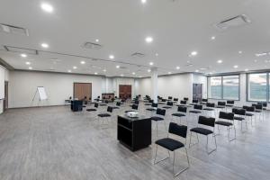 uma grande sala com filas de cadeiras e mesas em City Express by Marriott Torreon em Torreón