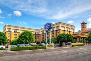 a large building with a blue sign in front of it at Hampton Inn Nashville / Vanderbilt in Nashville
