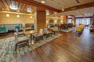 a waiting room with tables and chairs and a cafeteria at Hampton Inn Nashville / Vanderbilt in Nashville