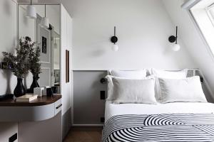 a white bedroom with a bed and a window at Best Western Premier The Blake Paris Gare Saint Lazare in Paris +31 photos