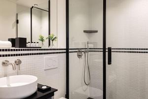 a bathroom with a shower and a sink at Best Western Premier The Blake Paris Gare Saint Lazare in Paris