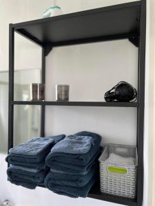 a shelf with blue towels and a basket on it at Lakeside Apartments in Egilsstadir