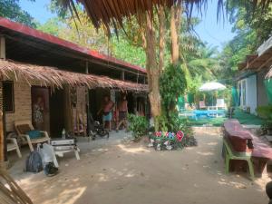 a courtyard of a house with a tree at Row House Long Beach in Krabi town