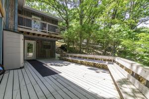 a house with a wooden deck with a balcony at 6bedrooms, ramp boat dock slips water toys, nice cove area in Linn Creek