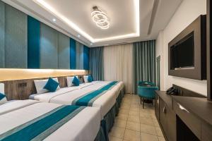 מיטה או מיטות בחדר ב-Best Western Ajyad Makkah