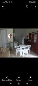 two pictures of a kitchen with a table and a white table at Recanto Renascer (hostel e Pousada) in Rio Branco
