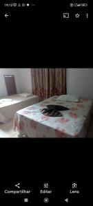 a picture of a room with a bed with a table at Recanto Renascer (hostel e Pousada) in Rio Branco