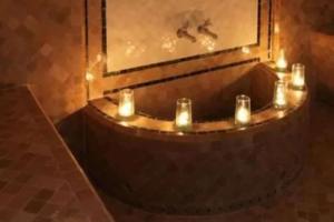 a bath tub with candles in front of a mirror at Dakhla South Bay in Dakhla