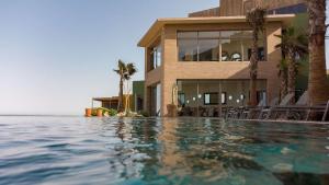 a house with a swimming pool next to the ocean at Dakhla South Bay in Dakhla