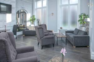 a living room with couches and chairs and a tv at Best Western The Grand Hotel Hartlepool in Hartlepool