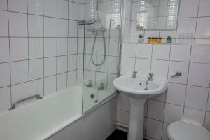 a white bathroom with a sink and a shower at Best Western The Grand Hotel Hartlepool in Hartlepool +75 photos