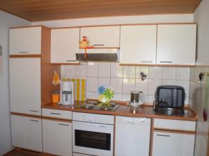 a kitchen with white cabinets and a counter top at -Heaf half between North and Ostsee U Schlei in Ellingstedt