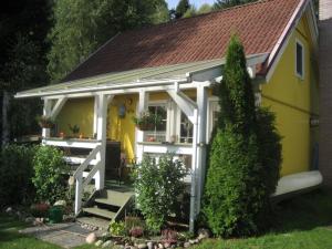 Casa blanca y amarilla con porche en Holiday home monkfish house en Warin