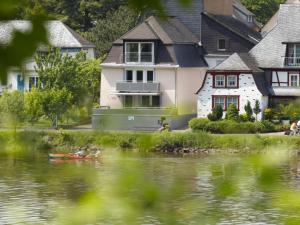 a house on the side of a river with houses at Holiday home on the Lay in Traben-Trarbach