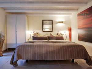 a bedroom with a large bed and a painting on the wall at Holiday home on the Lay in Traben-Trarbach