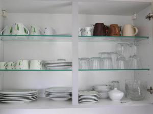 a cabinet filled with plates and cups and dishes at Epple in Tübingen am Neckar in Tübingen +10 photos