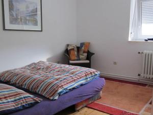 a bedroom with a bed and a chair at Epple in Tübingen am Neckar in Tübingen